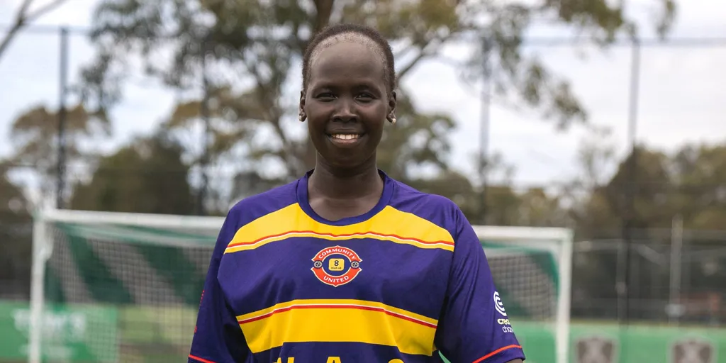 Anyier Yuol smiles on the soccer pitch